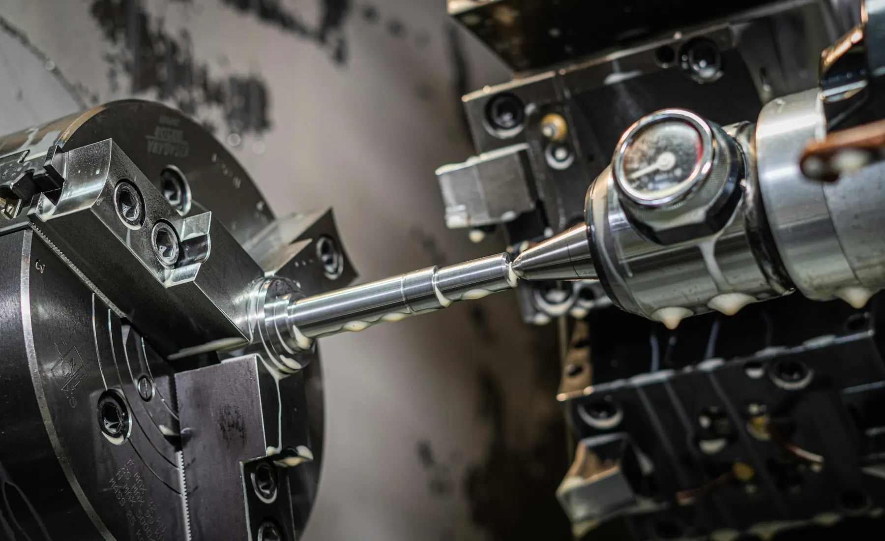 A chrome shaft turning on a CNC lathe
